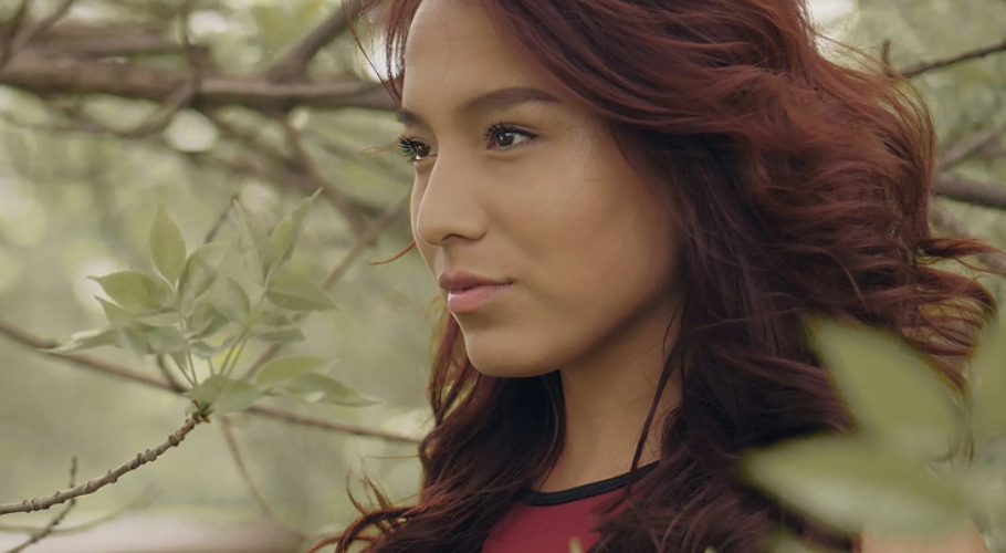 woman with red hair staring into distance